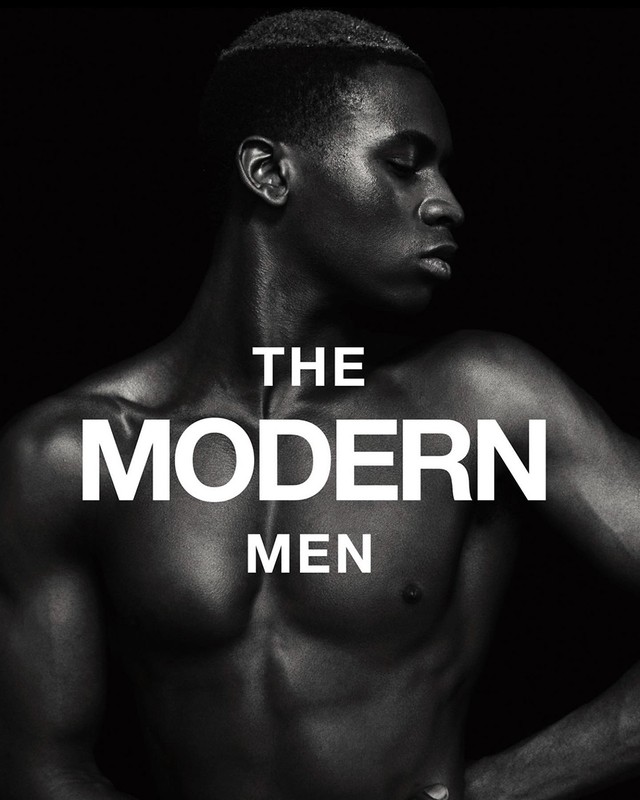 Monochromatic portrait of a muscular adult male with short hair in front of a dark backdrop and the text 'The Modern Men'.