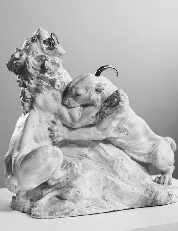Monochrome studio shot of a sculpture featuring a lioness nuzzling a lion cub, with detailed textures and a soft, diffused light.