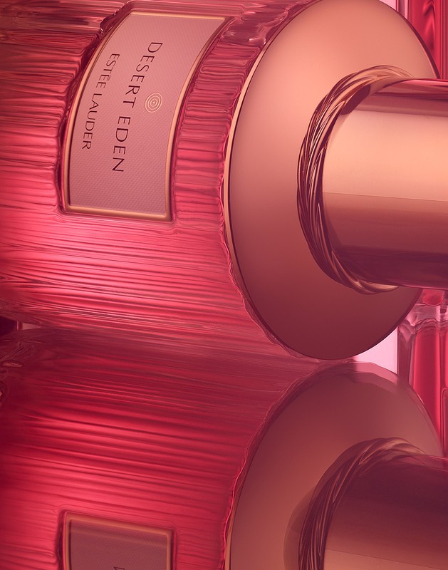 Close-up of a pink perfume bottle with ridged glass and metallic cap photographed by Coppi Barbieri
