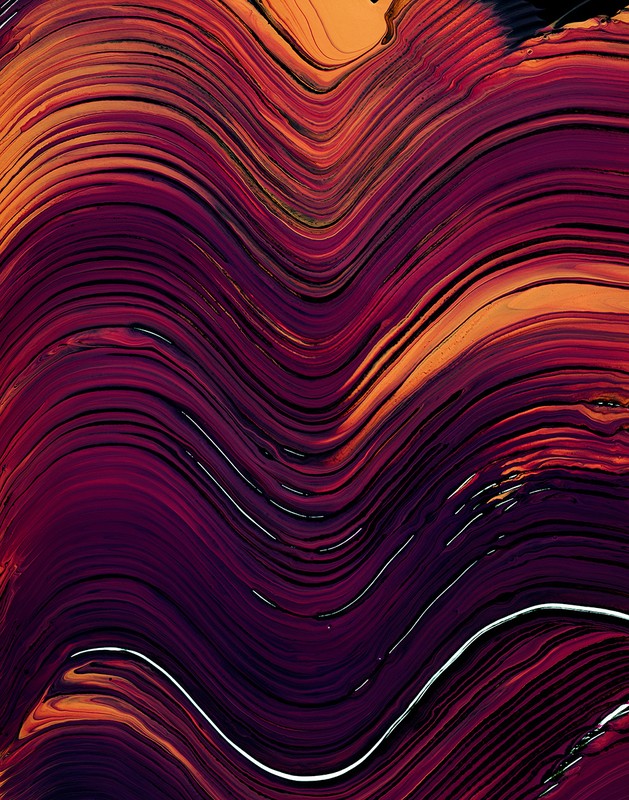 Abstract background image featuring flowing lines and swirls in shades of purple, red, orange, and white creating a dynamic composition.