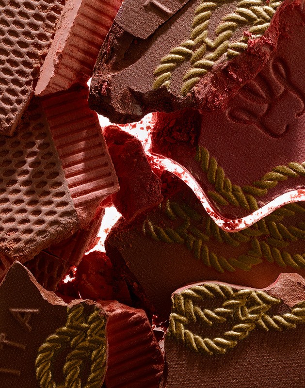 Macro photograph of broken bronzer powder showing pressed patterns, texture, and dominant earth tones in a beauty context.