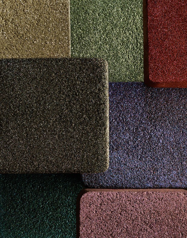 Abstract close-up of multi-colored, textured, rectangular mats in red, green, blue, pink, brown and grey shades, for backgrounds and textures.