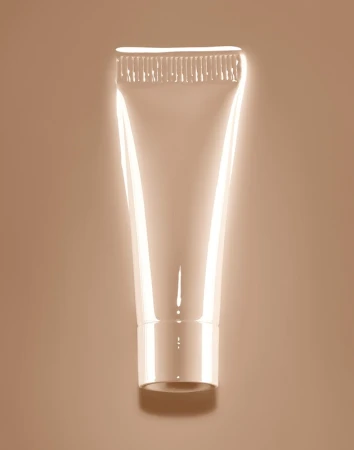 Close-up studio shot of a reflective, translucent squeeze tube, likely for cosmetics, set against a peach background.