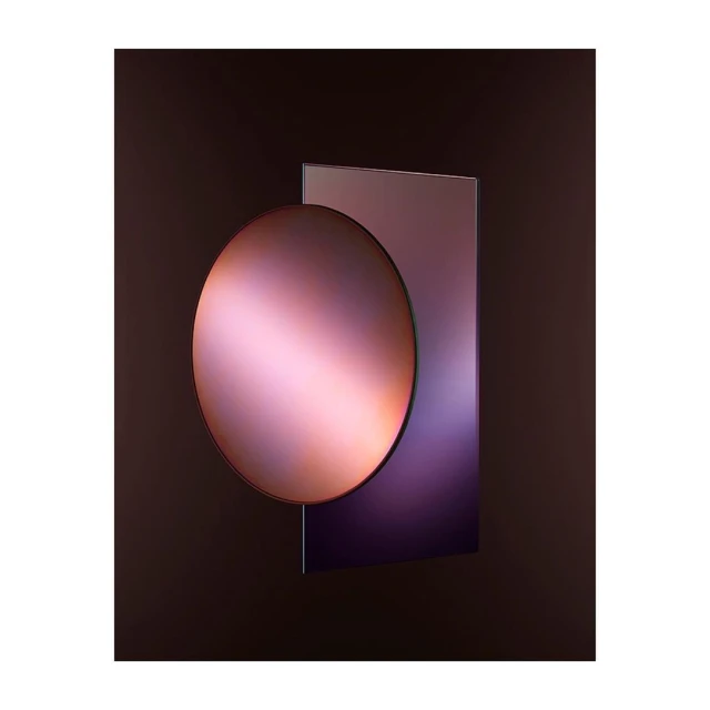 Abstract image with a smooth, reflective, round surface intersecting a square, set against a dark, shadowy background.