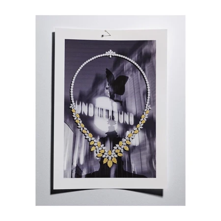 A black and white photograph of a diamond necklace, featuring a modern design and a butterfly motif in the background for luxury jewelry.
