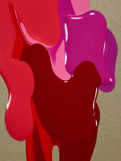 Abstract closeup of bright red, pink, and magenta nail polish dripping on a textured gold background, creating an interesting and colorful design.