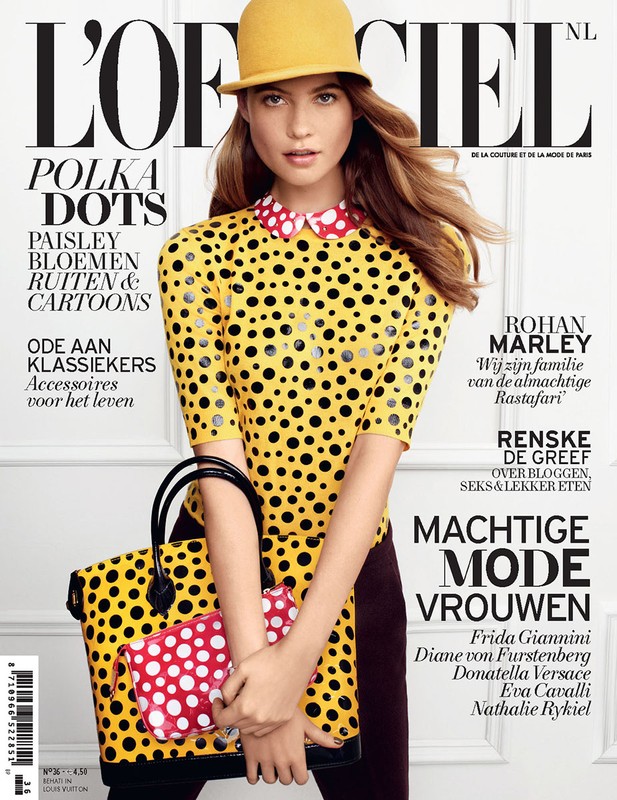 Magazine cover featuring a fair-skinned woman in a polka dot sweater, yellow hat, and carrying matching bags. 'L'Officiel' is at the top.