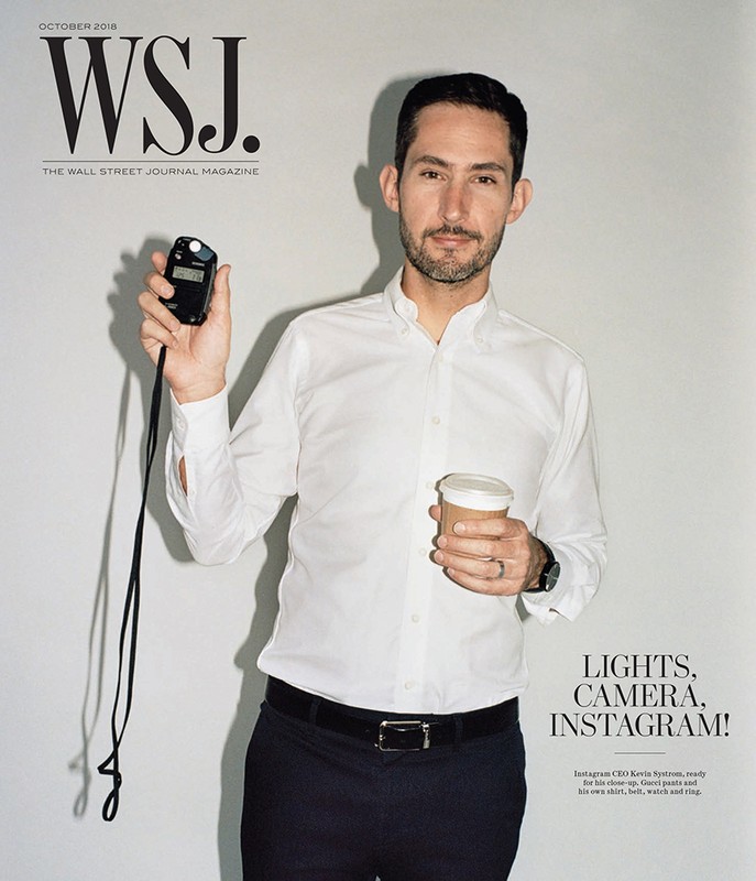 Magazine cover featuring a man in a white shirt holding a light meter and a coffee cup against a plain background, with magazine text overlay.