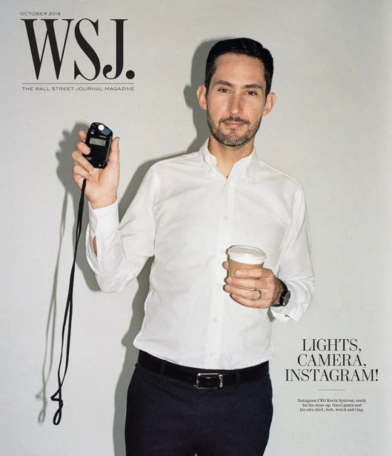 Magazine cover featuring a man in a white shirt holding a light meter and a coffee cup against a plain background, with magazine text overlay.