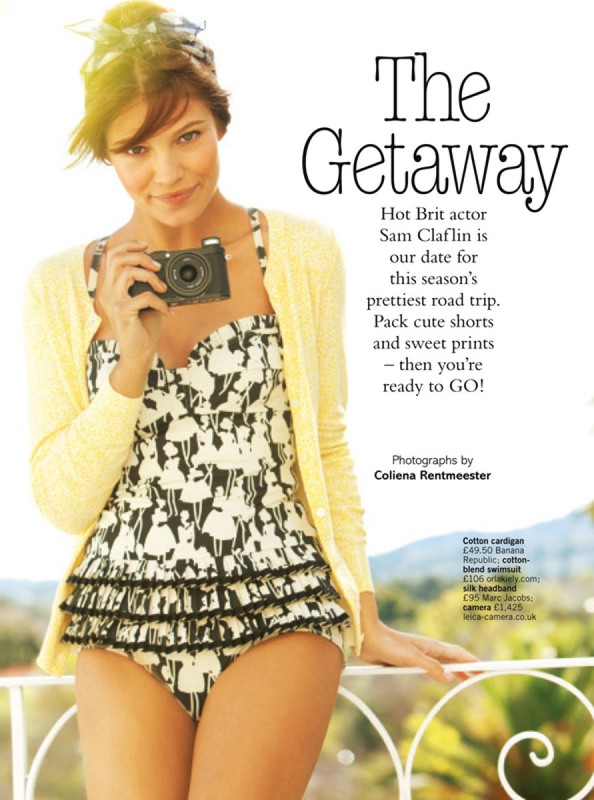 Woman in patterned swimsuit and yellow cardigan holding a camera, with hair styled by David Cox