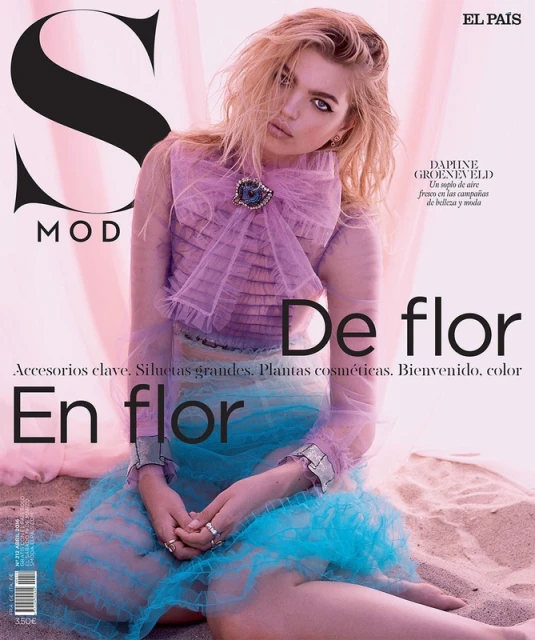 Magazine cover featuring a young woman in sheer lavender and teal tulle fabrics, posing on a sandy beach with the 'S MODA' logo.