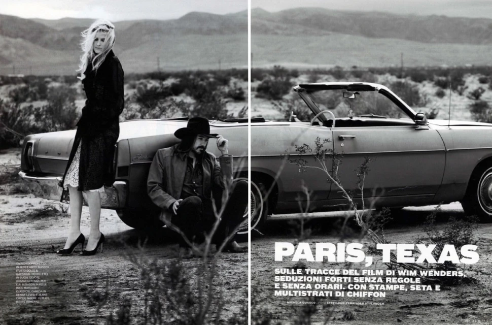 Black and white fashion editorial photo of a stylish woman and man with a vintage convertible car in an open desert landscape.
