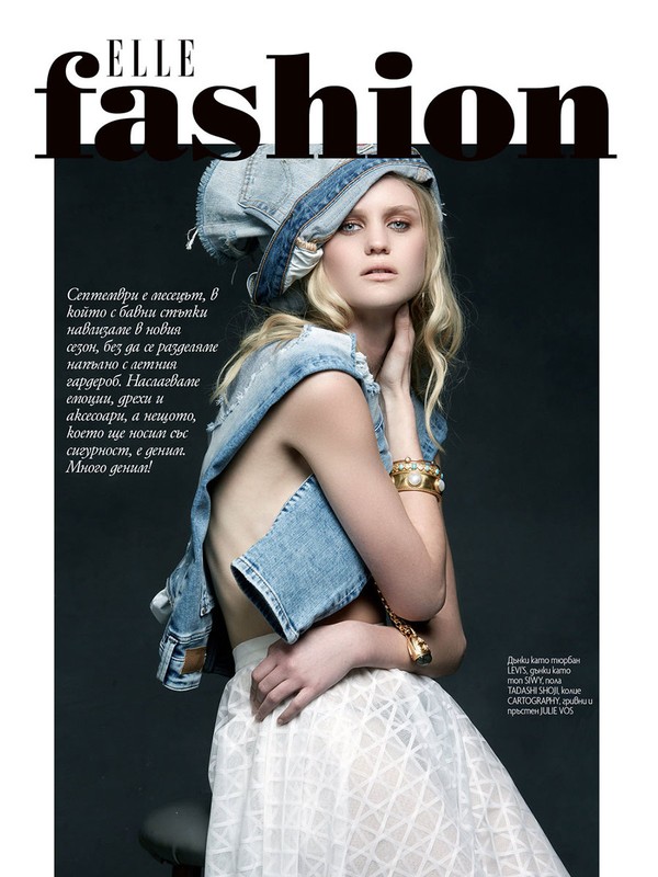 Elle Fashion magazine cover featuring a blonde woman wearing a denim hat and vest, and a white skirt, posing against a grey backdrop.