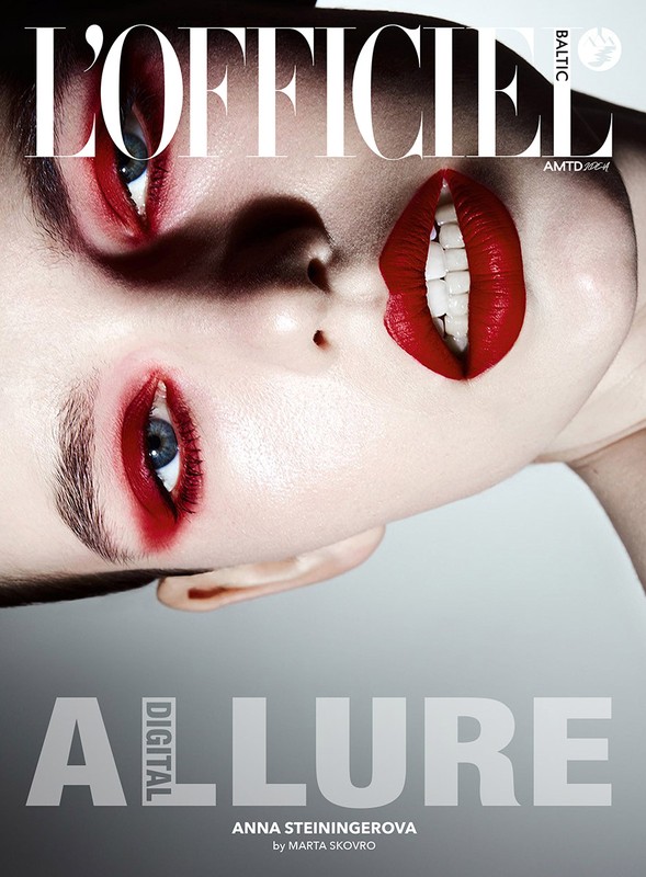 Fashion magazine cover featuring a close-up of a fair-skinned woman with bold red makeup, blue eyes, and the 'L'Officiel' logo.