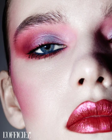 Close-up portrait of a woman with vibrant pink and purple eyeshadow and metallic pink lips by make-up artist David Razzano