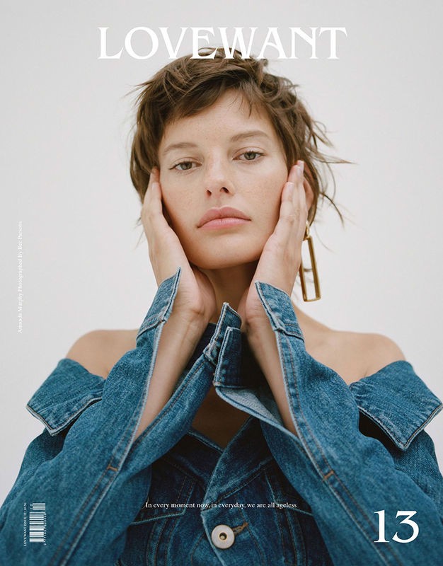 Fashion magazine cover featuring a young woman with short hair in a denim off-the-shoulder jacket, with hands framing her face.
