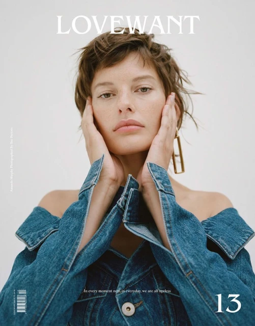 Fashion magazine cover featuring a young woman with short hair in a denim off-the-shoulder jacket, with hands framing her face.