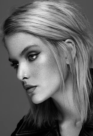 Close-up portrait of a woman with highlighted hair and winged eyeliner styled by Destiny Venice