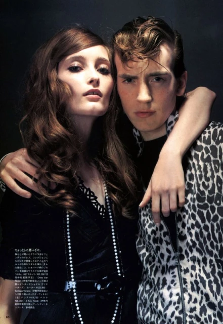 Stylish portrait of a fashionable couple, featuring a young adult woman with long wavy hair and a young adult man in a leopard-print jacket.