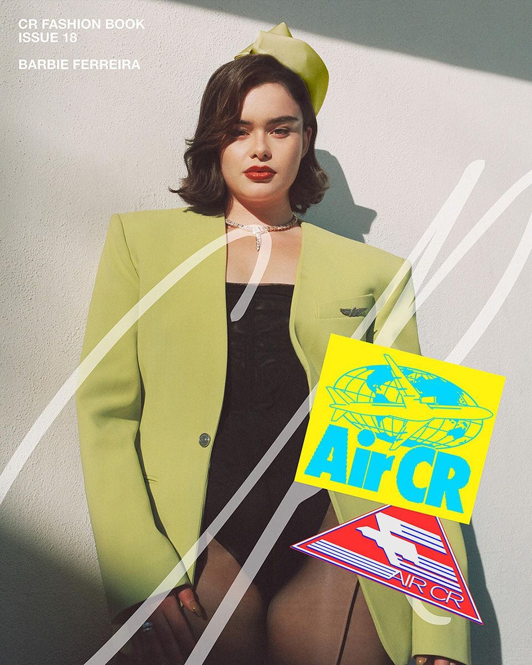 Woman poses in a lime-green suit with a matching hat and a black bodysuit. Airline stickers are overlaid on the image.