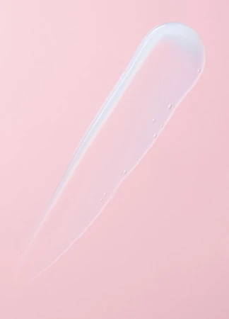 Clear gel serum skincare swatch on a pink background. Minimalist beauty and cosmetic product photography for skin treatment ad campaign.