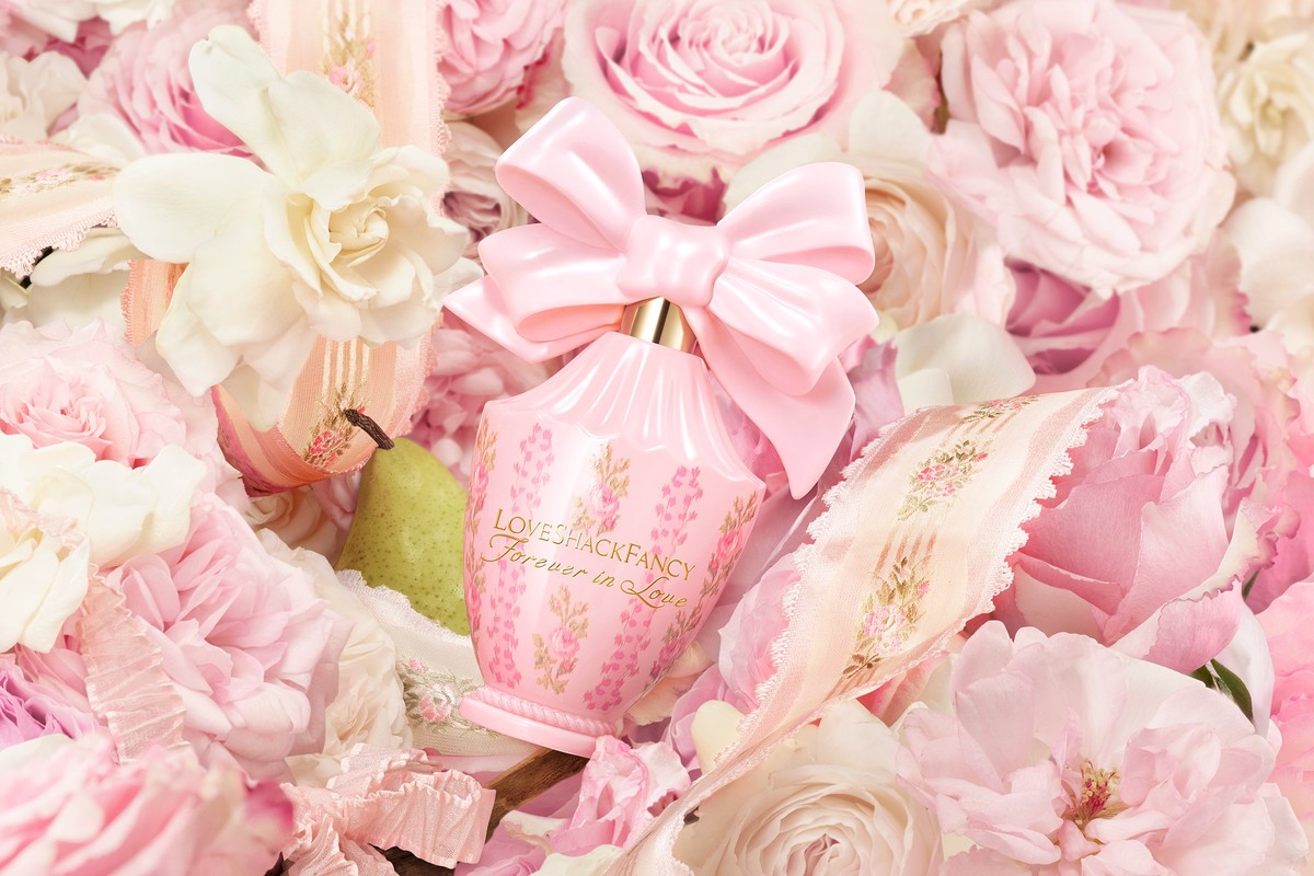 Pink perfume bottle with a bow surrounded by pink and white flowers and ribbons for beauty, fashion, and fragrance promotions.