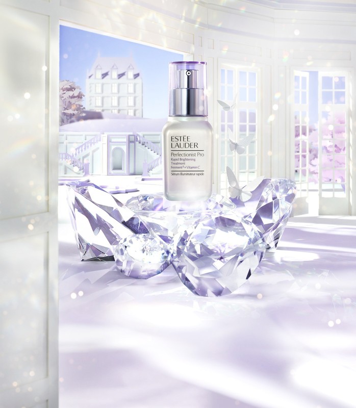 Estee Lauder serum bottle on a white surface with diamond props and white architectural background and butterfly effects.