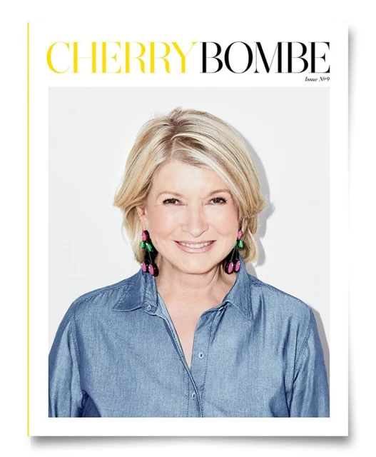 Close-up magazine cover featuring a smiling adult woman with short blond hair wearing a denim shirt against a white background.