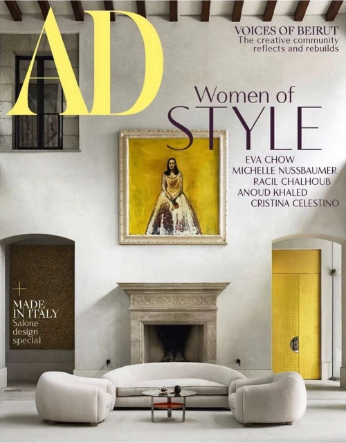 Architectural Digest cover featuring a room interior with white furniture, a painting, and a fireplace, creating a stylish and elegant ambiance.