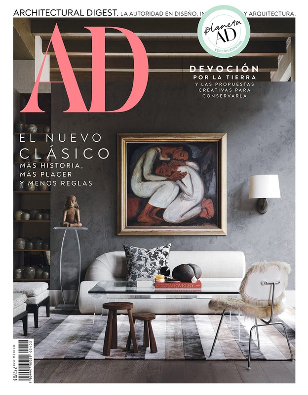 Architectural Digest magazine cover featuring a living room interior with modern furniture and a framed painting of embracing figures.