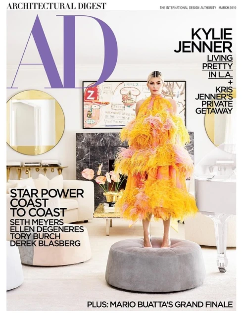 Architectural Digest magazine cover featuring Kylie Jenner in a tiered feather dress, set in a luxe living room with modern decor.