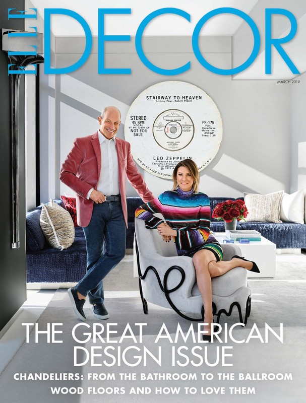 Elle Decor cover featuring two adults posing indoors with furniture, a record, and interior design elements.