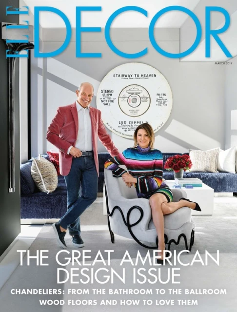 Elle Decor cover featuring two adults posing indoors with furniture, a record, and interior design elements.