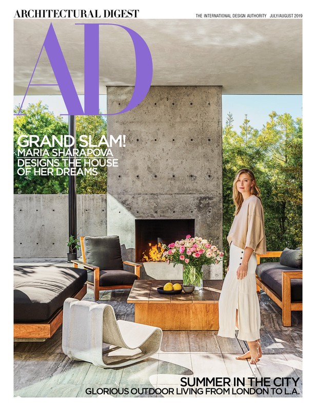 Architectural Digest cover featuring Maria Sharapova in an outdoor living space with modern furniture, flowers, and a concrete fireplace.