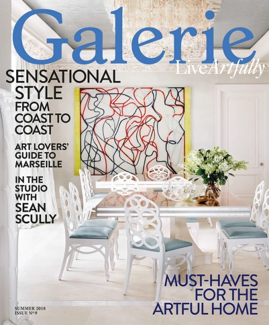 Galerie magazine cover featuring interior design with white dining chairs, marble table, and modern art. Indoor setting, stylish home.