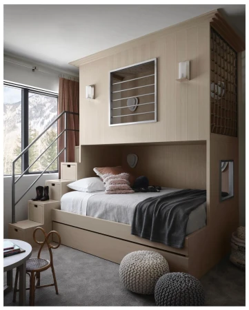 Cozy child's bedroom featuring a custom-built bunk bed with stairs, complemented by natural light and neutral tones, creating a comforting space.