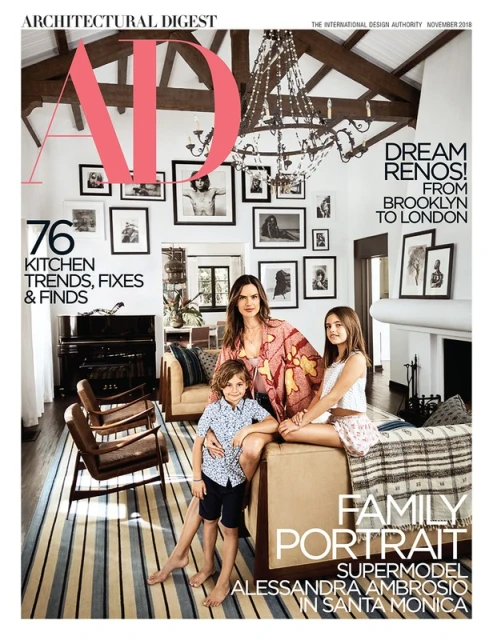Magazine cover featuring a portrait of Alessandra Ambrosio with her children, set in a room with a piano, artwork, and striped rug.
