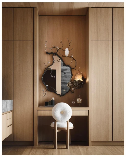 Interior design with a wooden vanity featuring a decorative mirror, a white round chair, and wooden paneled walls and floor.