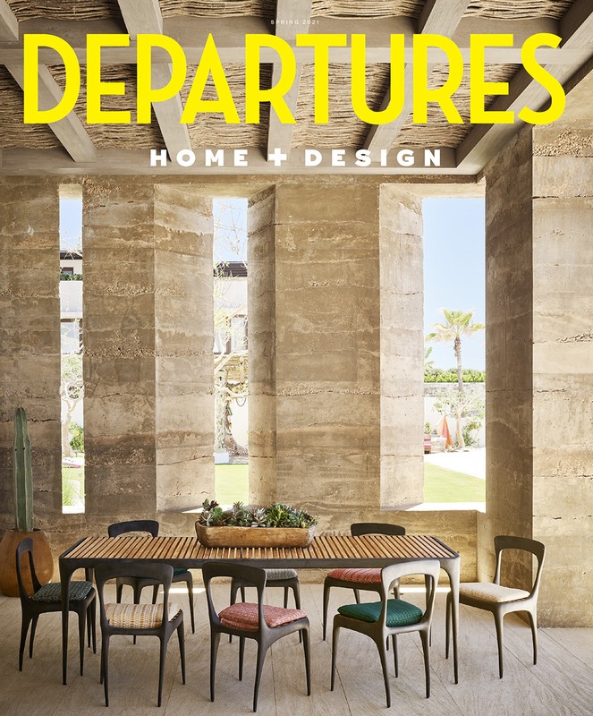 Indoor dining area with wooden table, chairs, and minimalist architectural design, featuring magazine cover 'Departures Home + Design'.