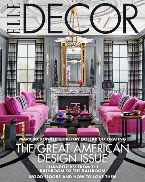 Elle Decor magazine cover featuring a symmetrically styled living room with pink sofas, a marble fireplace, and a chandelier.
