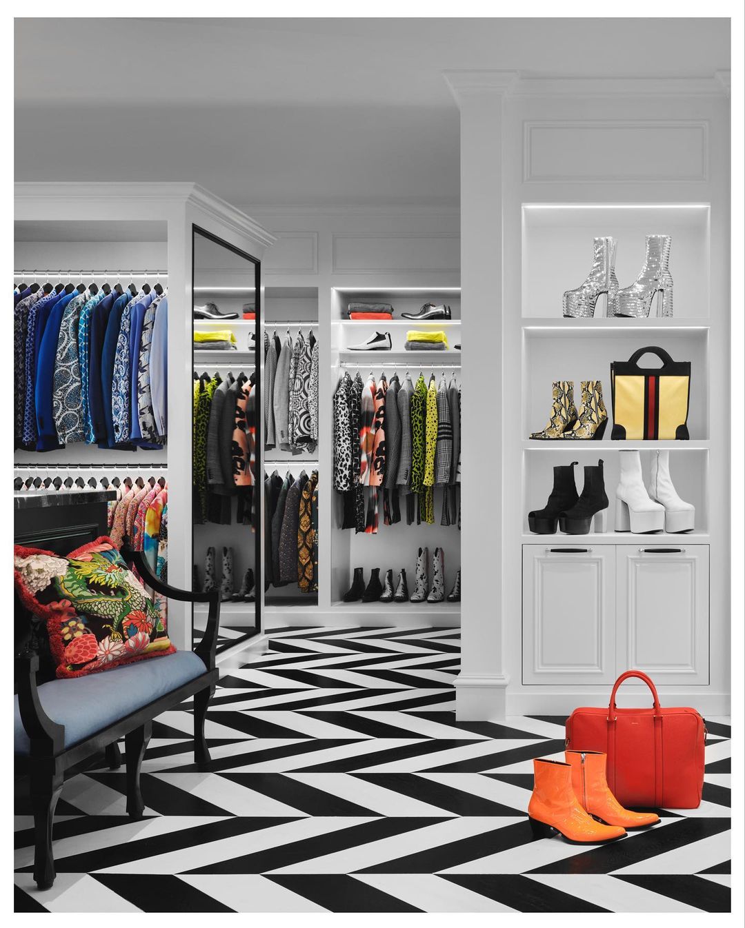 An interior view shows a luxurious, organized closet with various shoes, bags, and clothing, set against a bold black and white chevron floor.