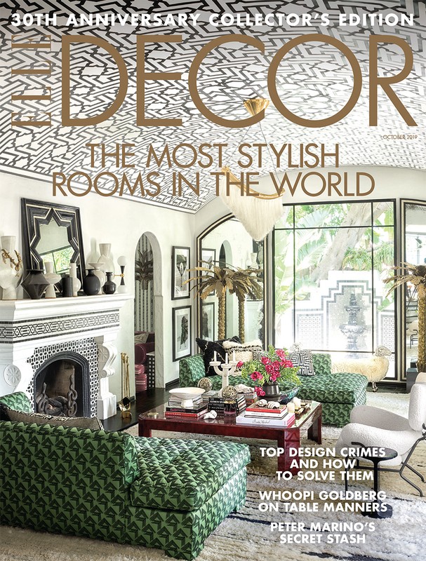 ELLE DECOR magazine cover showcasing a stylishly decorated interior with patterned walls, furniture, fireplace, and various decorative objects.