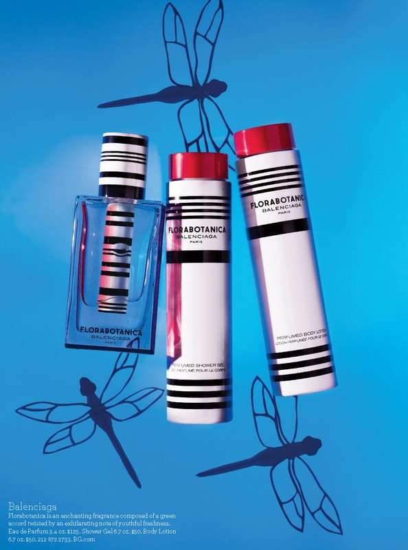 Balenciaga Florabotanica perfume bottle and body lotion products with dragonfly shadows on a light blue background. Beauty shot.