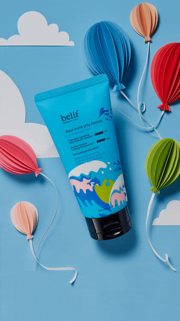 Blue cosmetic tube with water wave design surrounded by colorful paper balloons against a blue background with white paper clouds.