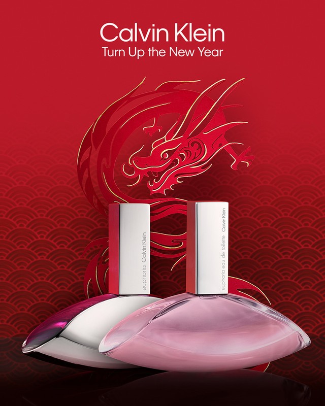 Two Calvin Klein Euphoria perfume bottles are displayed against a red backdrop with a golden dragon illustration and wave pattern.