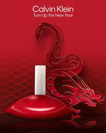 Calvin Klein's 'my euphoria' perfume bottle is showcased against a red dragon design, celebrating the New Year with elegance.