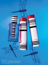 Three Balenciaga Florabotanica fragrance and body product bottles arranged on a bright blue background with dragonfly silhouettes.