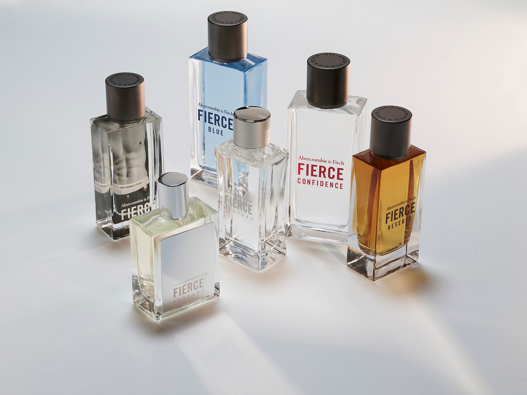 Six Abercrombie & Fitch 'Fierce' cologne bottles in clear glass and various scents are arranged on a light surface, creating a modern still life.