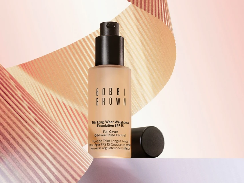 Bobbi Brown Skin Long-Wear Weightless Foundation SPF 15 product shot on a white surface with peach-toned striped background.