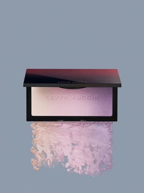 Kevyn Aucoin highlighter palette displayed on a grey backdrop with diffused product swatch underneath. Makeup and beauty.